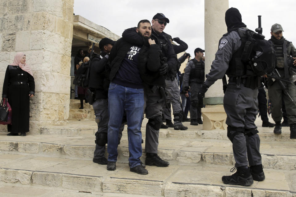 Israeli police arrests aPalestinian at al Aqsa mosque compound in Jerusalem, Monday, Feb. 18, 2019. Israeli police officers have arrested several Palestinians for "causing a disturbance" at a flashpoint Jerusalem holy site. The men took part in a prayer protest Monday outside a section of the Temple Mount that has been closed by Israeli court order for over a decade. (AP Photo/Mahmoud Illean)