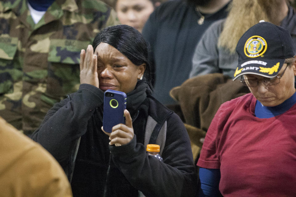 Veteran Tatiana McLee wipes tears from her eyes as she films Lakota elders speak during the&nbsp;forgiveness ceremony.