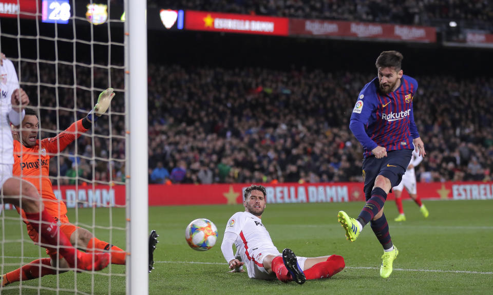 FC Barcelona's Lionel Messi, right, kicks the ball during a Spanish Copa del Rey soccer match between FC Barcelona and Sevilla at the Camp Nou stadium in Barcelona, Spain, Wednesday, Jan. 30, 2019. (AP Photo/Manu Fernandez)