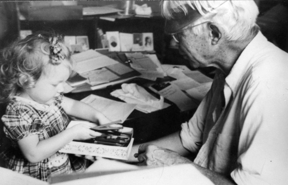 Carl Sandburg spends time with his granddaughter, Paula, at their home in Flat Rock in the late 1940s.