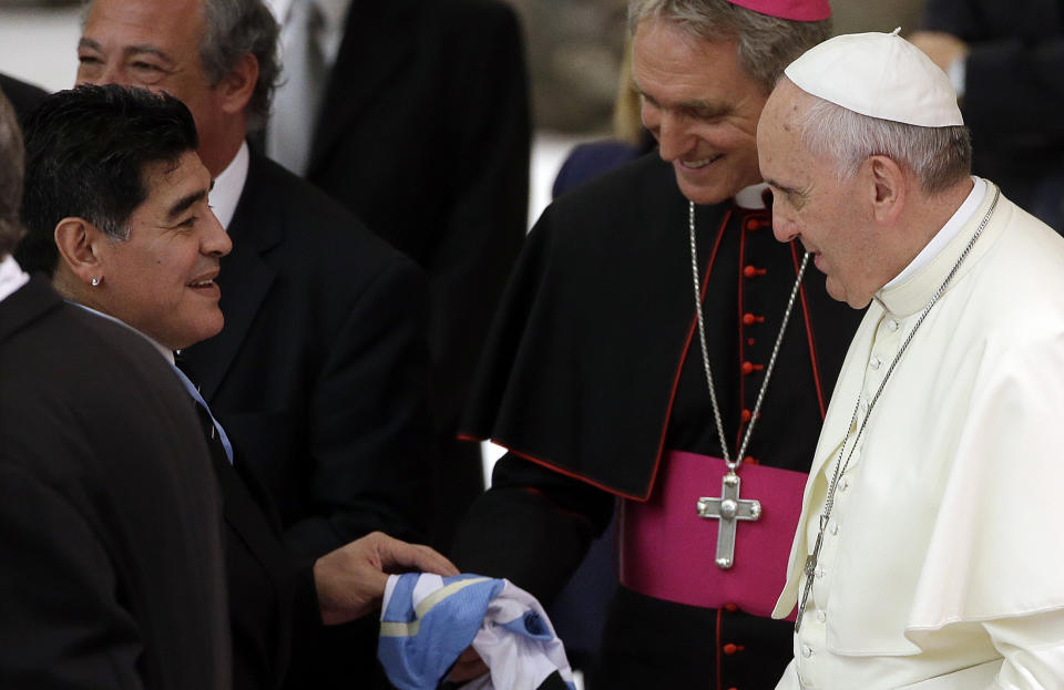 FILE -- In this Sept. 1, 2014 file photo, Argentine soccer legend Diego Armando Maradona, left, greets Pope Francis in the Paul VI hall at the Vatican. Diego Maradona says he's Pope Francis' top fan. The Argentine soccer great who was among the best players ever and who led his country to the 1986 World Cup title died from a heart attack on Wednesday, Nov. 25, 2020, at his home in Buenos Aires. He was 60. (AP Photo/Gregorio Borgia, File)