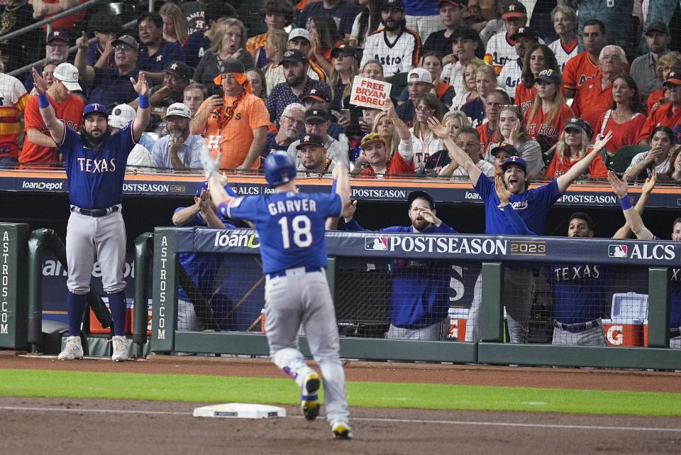 Texas Rangers' Mitch Garver reacts after hitting a home run during the second inning of Game 6 of the baseball AL Championship Series Sunday, Oct. 22, 2023, in Houston. (AP Photo/Tony Gutierrez)