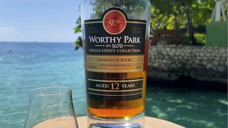 worthy park rum bottle by water