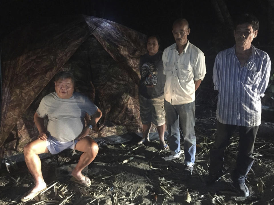 File - In this photo released by the Thailand Department of National Parks, Wildlife and Plant Conservation, the president of Thailand's largest construction company Premchai Karnasuta, 63, left, is seen with a group while being detained in the Thungyai Naresuan Wildlife Sanctuary in Kanchanaburi province on Thailand's western border, on Feb. 4, 2018. Karnasuta convicted poaching protected animals in a wildlife reserve was freed Tuesday Oct. 17, 2023 on parole two months ahead of the end of his prison term. (Thailand Department of National Parks, Wildlife and Plant Conservation via AP, File)