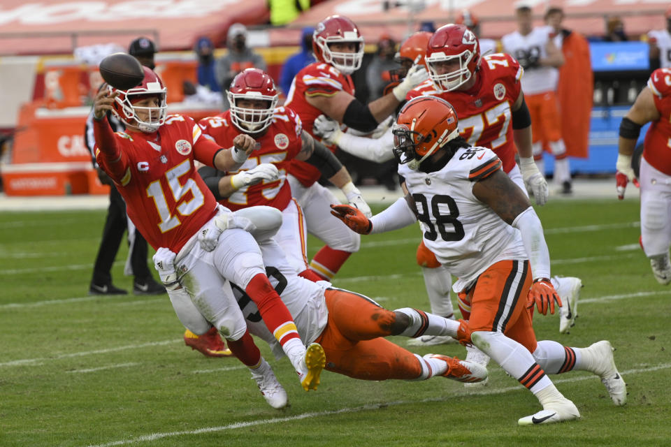 Kansas City Chiefs quarterback Patrick Mahomes (15) throws a pass in front of Cleveland Browns defensive tackle Sheldon Richardson, right, during the second half of an NFL divisional round football game, Sunday, Jan. 17, 2021, in Kansas City. (AP Photo/Reed Hoffmann)