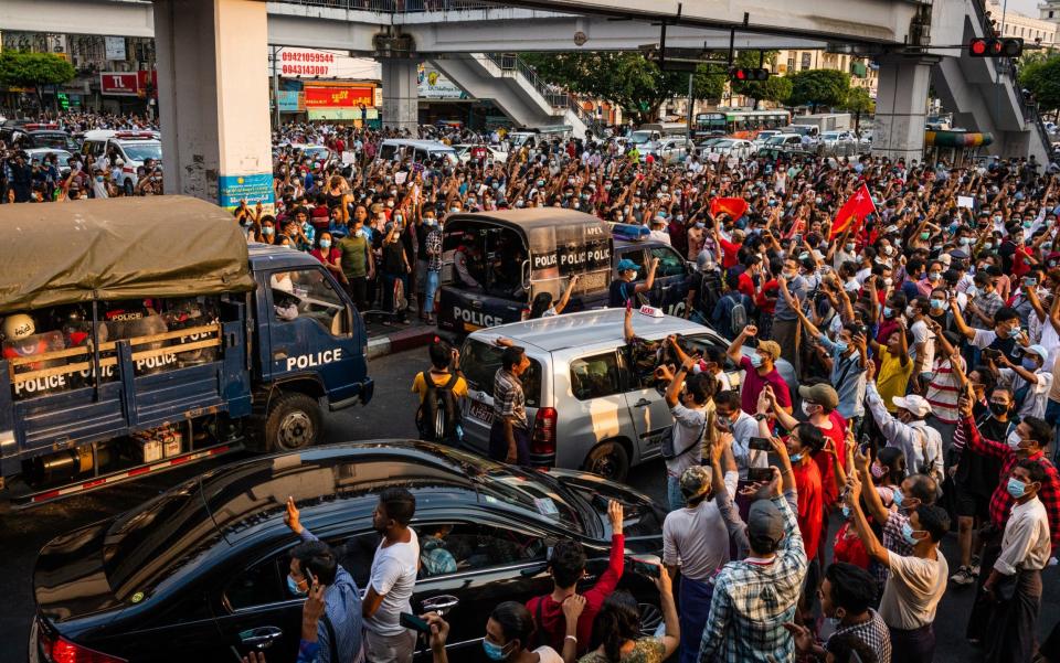 Protesters attempt to block riot police arriving to form a barricade outside Yangon City Hall on the weekend - Getty