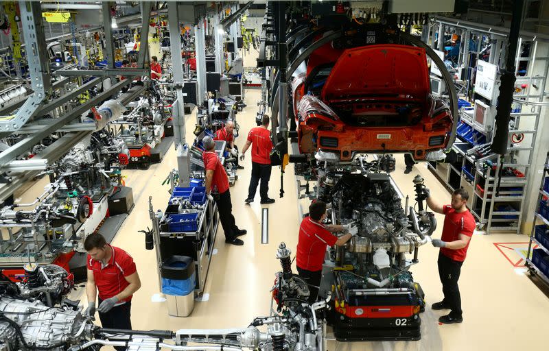 FILE PHOTO: Employees of German car manufacturer Porsche assemble sports cars at the Porsche factory in Stuttgart-Zuffenhausen