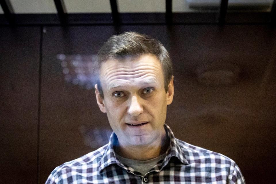 Russian opposition leader Alexei Navalny looks at photographers from inside a glass cage in the Babuskinsky District Court in Moscow (Copyright 2021 The Associated Press. All rights reserved.)