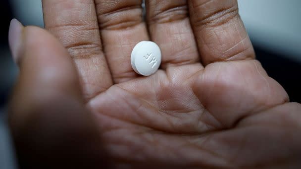 PHOTO: A patient prepares to take Mifepristone, the first medication in a medical abortion, at a clinic in Carbondale, Illinois, April 20, 2023. (Evelyn Hockstein/Reuters)