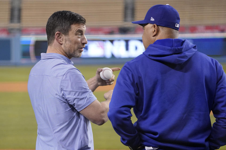 Los Angeles Dodgers President of Baseball Operations Andrew Friedman, left, talks with manager Dave Roberts during baseball practice Monday, Oct. 10, 2022, in Los Angeles for the National League division series against the San Diego Padres. (AP Photo/Mark J. Terrill)