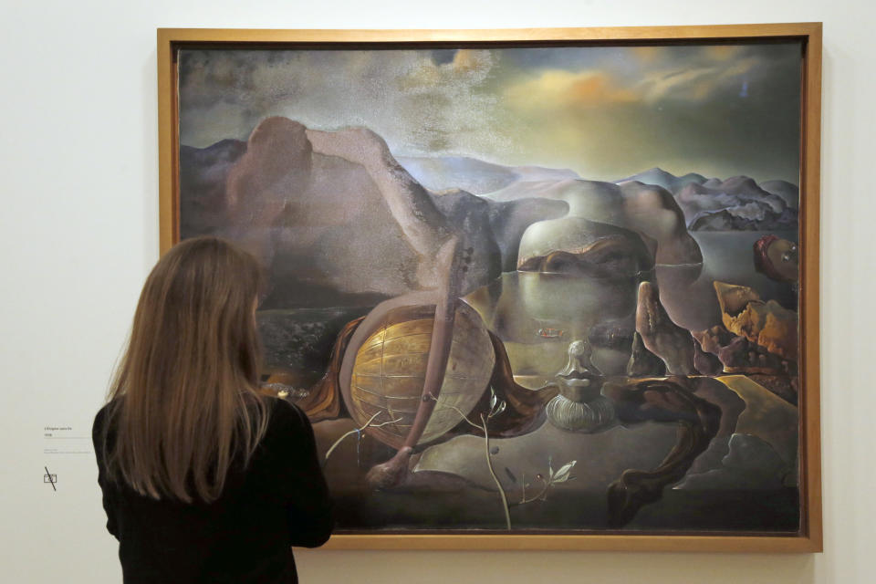 A visitor looks at a painting entitled 'L'enigme sans fin' (Endless enigma) by Spanish surrealist artist Salvador Dali during an exhibition devoted to his work at the Centre Pompidou contemporary art center (aka Beaubourg) on November 19, 2012 in Paris. More than 30 years after the first retrospective in 1979, the event gathers more than 200 art pieces and runs until March 13, 2013. (FRANCOIS GUILLOT/AFP/Getty Images)