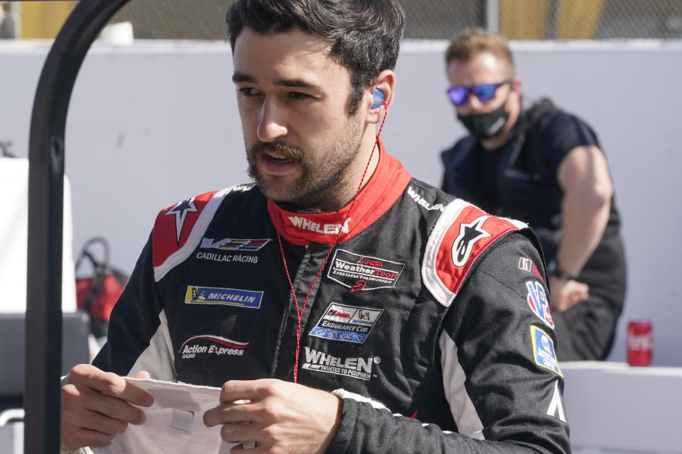 Chase Elliott prepares himself on pit road before the start of the Rolex 24 hour auto race at Daytona International Speedway, Saturday, Jan. 30, 2021, in Daytona Beach, Fla. (AP Photo/John Raoux)