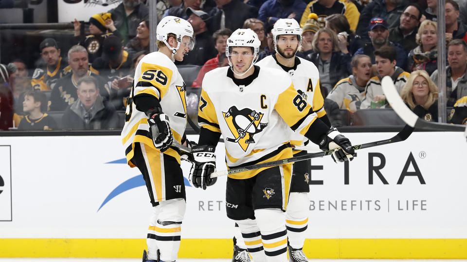 Sidney Crosby (87), Jake Guentzel (59) and Kris Letang (58) get ready for a faceoff. (Photo by Fred Kfoury III/Icon Sportswire via Getty Images)