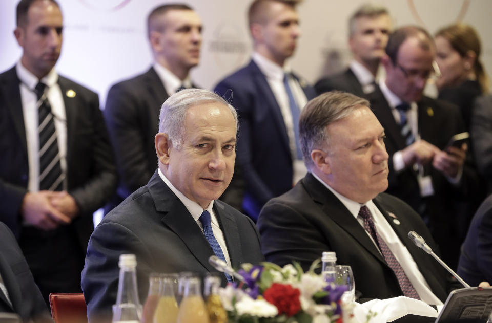 Israeli Prime Minister Benjamin Netanyahu, left, sits beside United State Secretary of State Mike Pompeo, right, at a conference on Peace and Security in the Middle East in Warsaw, Poland, Thursday, Feb. 14, 2019. The Polish capital is host for a two-day international conference, co-organized by Poland and the United States. (AP Photo/Michael Sohn)