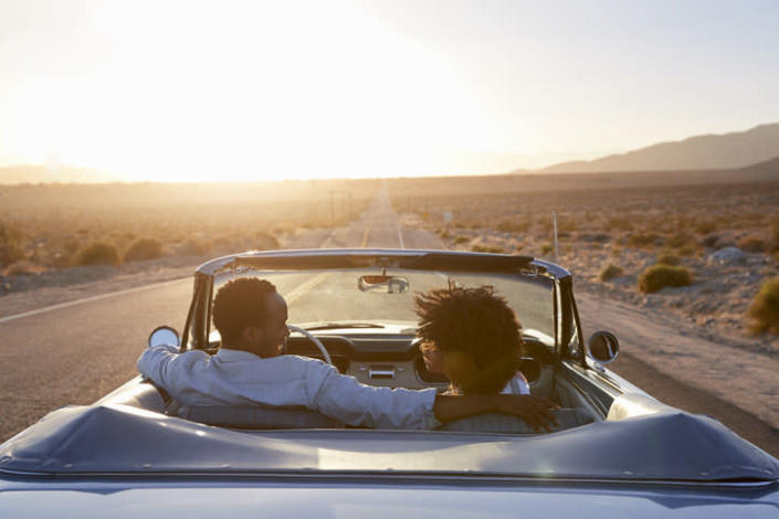 couple driving in a convertible