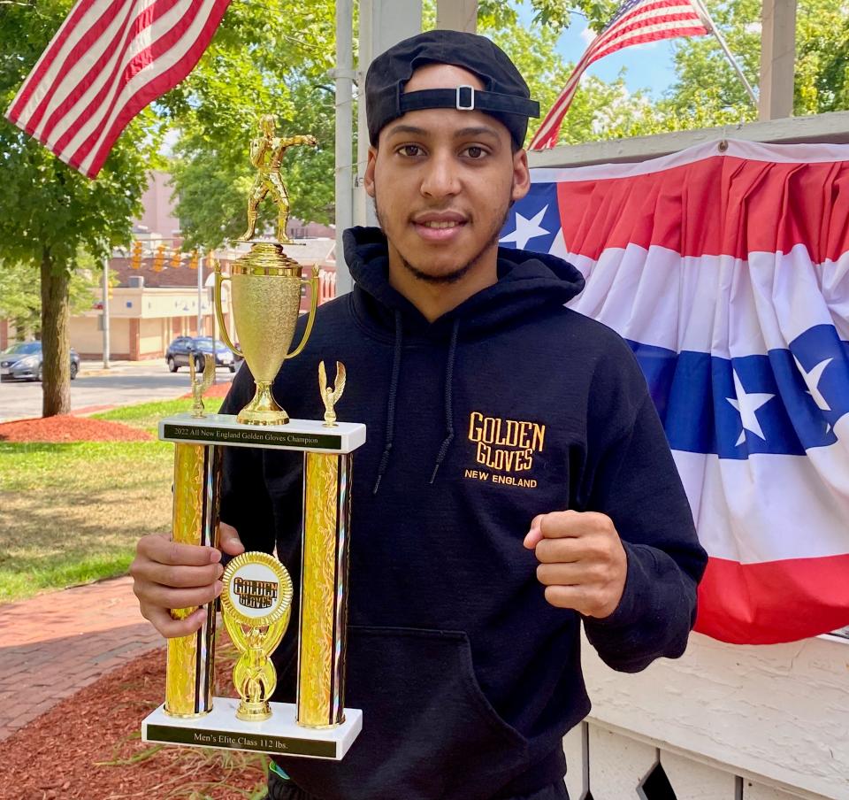 Ricardo Espertin. current Fitchburg and former Worcester resident, holds the trophy he won from winning the 112-pound elite division championship at the New England Golden Gloves Championships in Lowell in March.