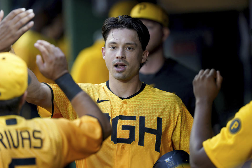 Pittsburgh Pirates' Bryan Reynolds celebrates in the dugout after scoring on a fielder's choice hit into by Joshua Palacios against the Chicago Cubs in the first inning of a baseball game in Pittsburgh, Friday, Aug. 25, 2023. (AP Photo/Matt Freed)