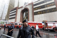 New York City Police and Fire Department personnel secure the scene in front of a building in midtown Manhattan where a helicopter crash landed, Monday, June 10, 2019. The Fire Department says the helicopter crash-landed on the top of the tower, which isn't far from Rockefeller Center and Times Square. (AP Photo/Richard Drew)