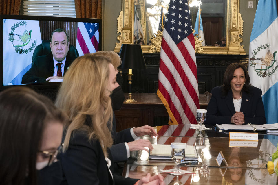 Vice President Kamala Harris, right, meets virtually with Guatemala's President Alejandro Giammattei, seen on screen at left, Monday, April 26, 2021, from her ceremonial office at the Eisenhower Executive Office Building on the White House complex in Washington. (AP Photo/Jacquelyn Martin)