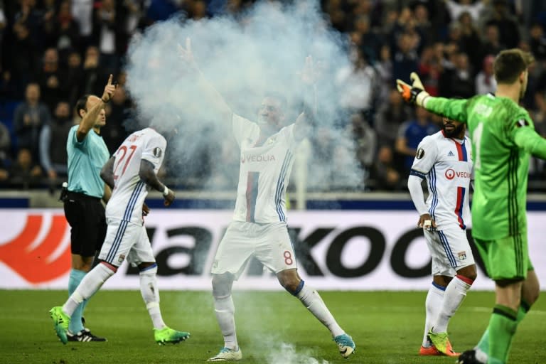 Lyon's French midfielder Corentin Tolisso (C) celebrates after scoring a goal against Besiktas during the UEFA Europa League first leg quarter final football match on April 13, 2017, at the Parc Olympique Lyonnais stadium in Decines-Charpieu