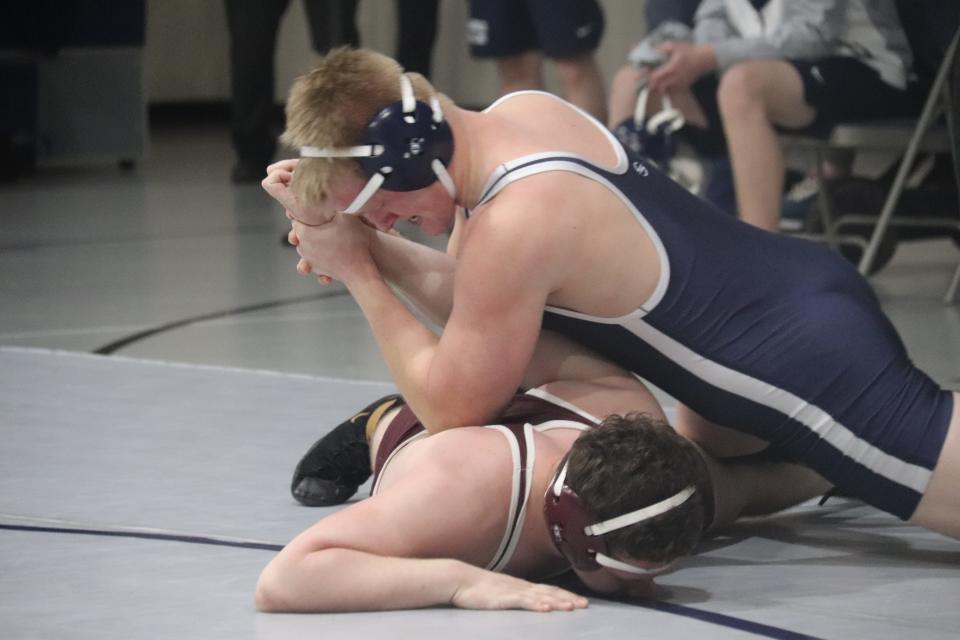 Shawnee's Sam Anderson locks up the arm of Ada's Logen Prince in the 195-pound match Tuesday night at the Stucker Complex.