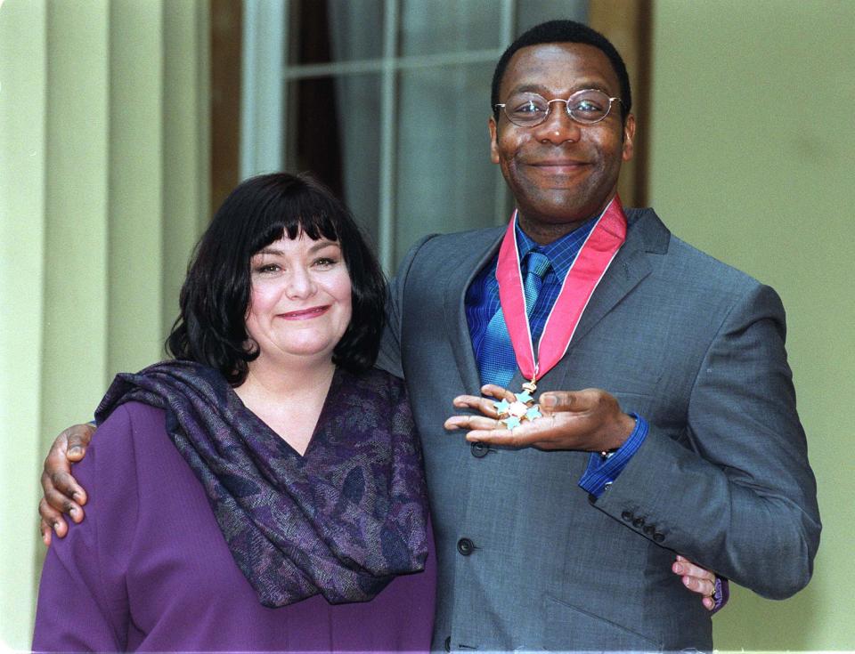 Comedian Lenny Henry and wife Dawn French, also a comedian, pose at Buckingham Palace in London after Lenny was presented with a CBE (Commander of the British Empire) from the Queen.  24/5/99: N/paper report that Henry met blonde woman at hotel.   (Photo by Fiona Hanson - PA Images/PA Images via Getty Images)