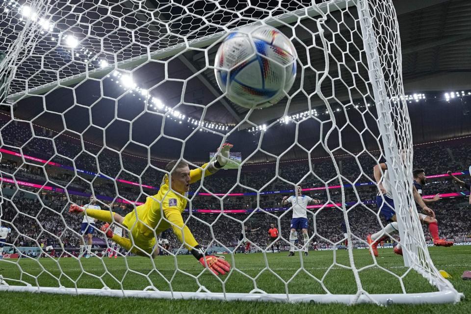 England goalkeeper Jordan Pickford is beaten on a header by France's Olivier Giroud.