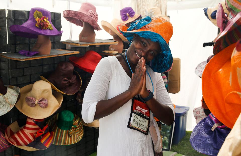 Hat maker Fatou Sall presents her creations at the Kentuck Festival of the Arts in Kentuck Park on Oct. 21, 2017.