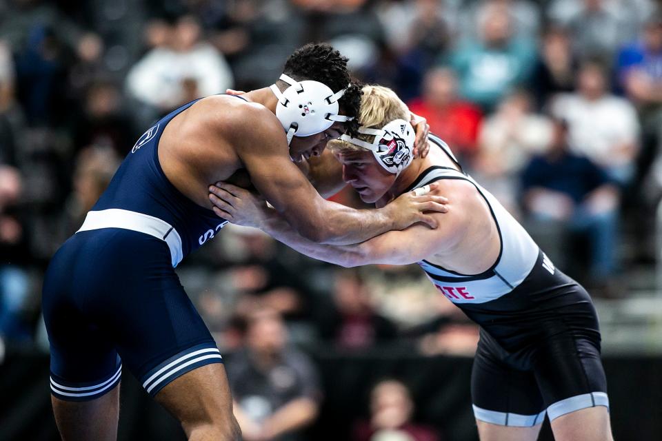 Penn State's Carter Starocci, left, wrestles NC State's Hayden Hidlay at 174 pounds in the semifinals of the NCAA Division I Wrestling Championships on Friday at Little Caesars Arena in Detroit. Starocci won 10-3 to advance to the national championship match.