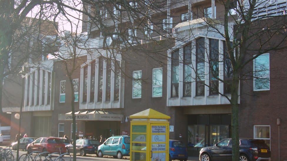 Outside of Jersey hospital with cars in front