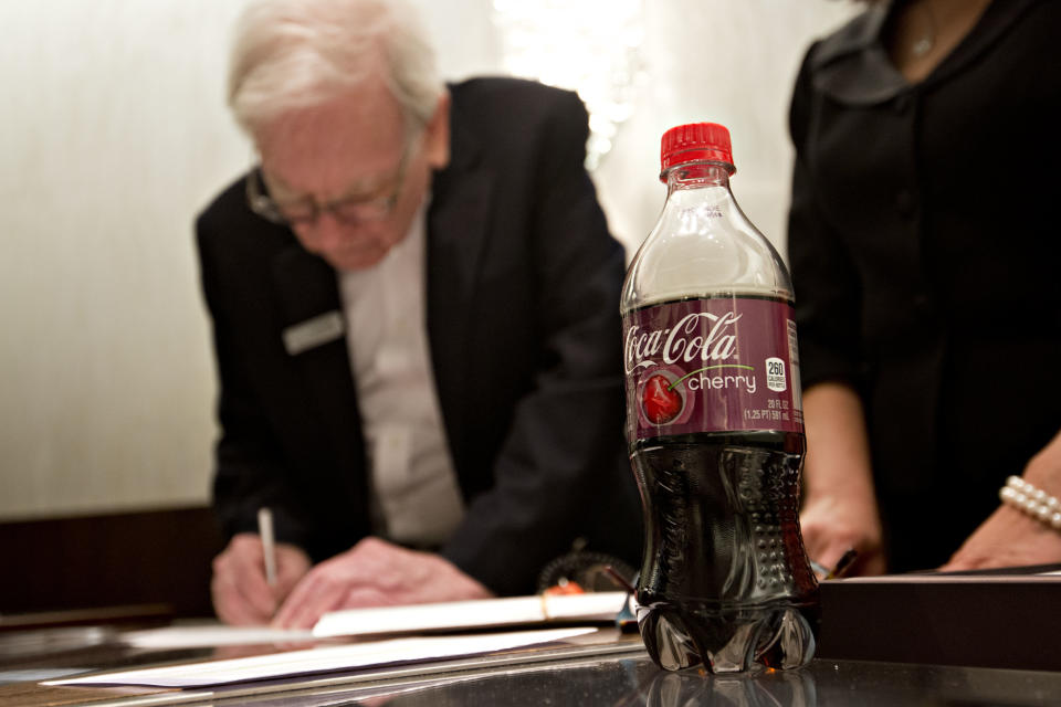 A Cherry Coca-Cola sits on the counter as Warren Buffett, chairman of Berkshire Hathaway Inc., sells jewelry at Borsheim's Jewelry on the sidelines of the Berkshire Hathaway shareholders meeting in Omaha, Nebraska, U.S., on Sunday, May 4, 2014. Warren Buffett whose Berkshire Hathaway Inc. joined 3G Capital last year in a $23.3 billion takeover of ketchup maker HJ Heinz Co., said yesterday he'd welcome more deals with the buyout firm. Photographer: Daniel Acker/Bloomberg via Getty Images 