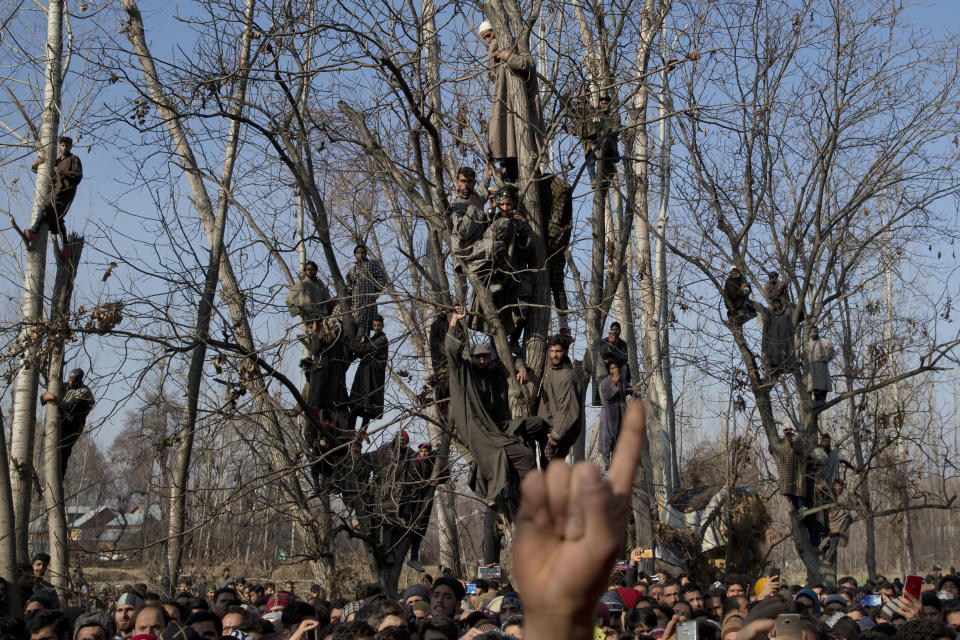 Kashmiri villagers watch the funeral of Zahoor Ahmed, soldier turned rebel, in Pulwama, south of Srinagar, Indian controlled Kashmir, Saturday, Dec. 15, 2018. At least seven civilians were killed and nearly two dozens injured when government forces fired at anti-India protesters in disputed Kashmir following a gunbattle that left three rebels and a soldier dead on Saturday, police and residents said. (AP Photo/ Dar Yasin)