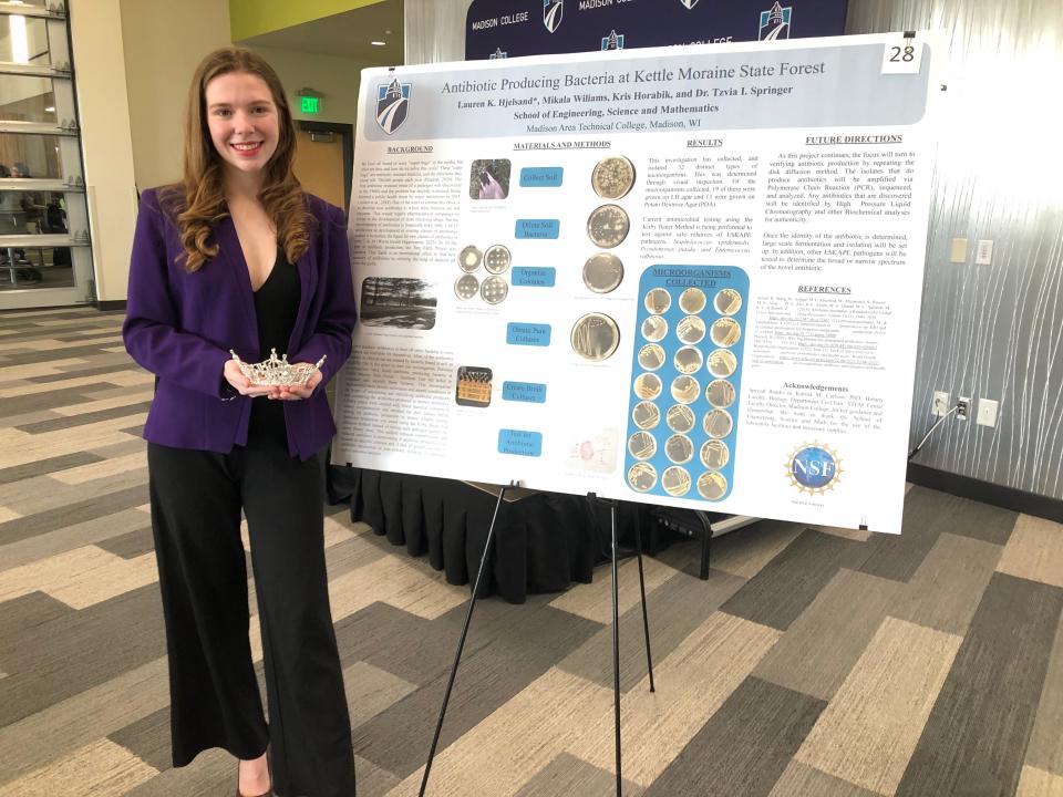 Lauren Hjelsand stands with her research on antibiotic-producing bacteria at Kettle Moraine State Forest.