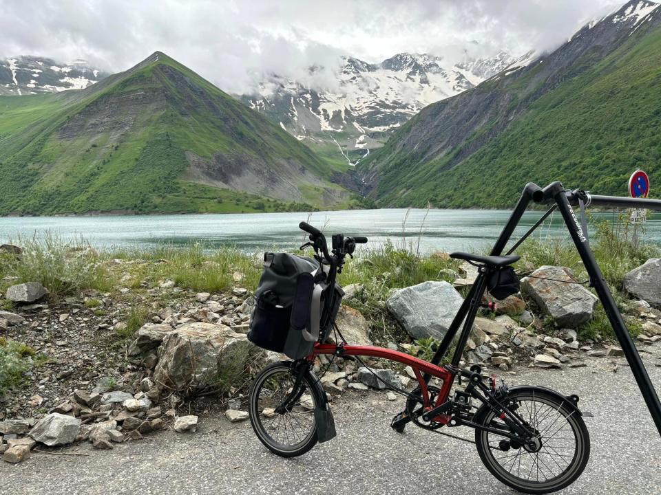A foldable bike in front of a snowy mountain range