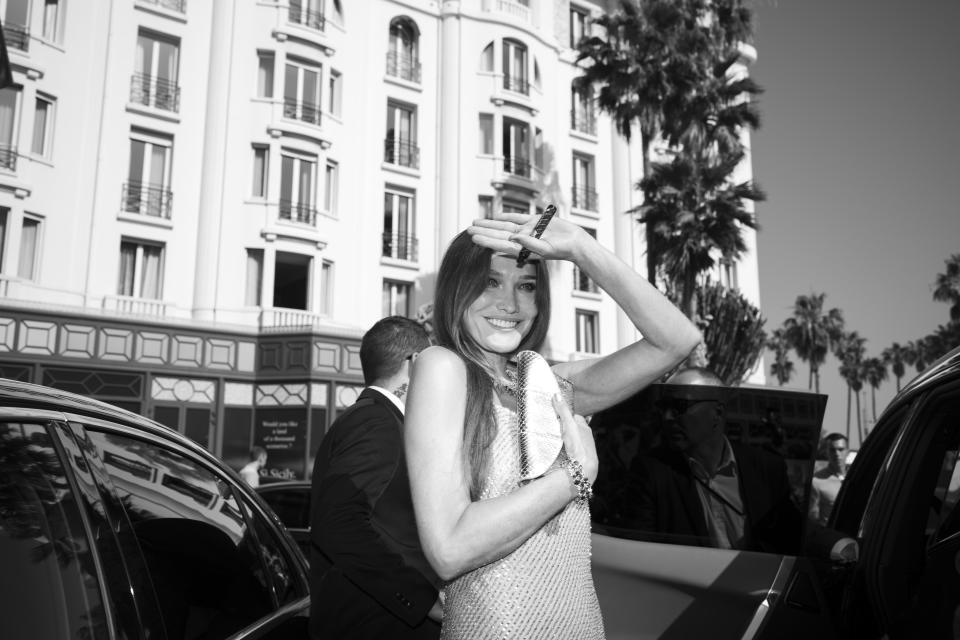 Carla Bruni leaves from the Majestic hotel for the premiere of the film 'Triangle of Sadness' at the 75th international film festival, Cannes, southern France, Saturday, May 21, 2022. (AP Photo/Petros Giannakouris)