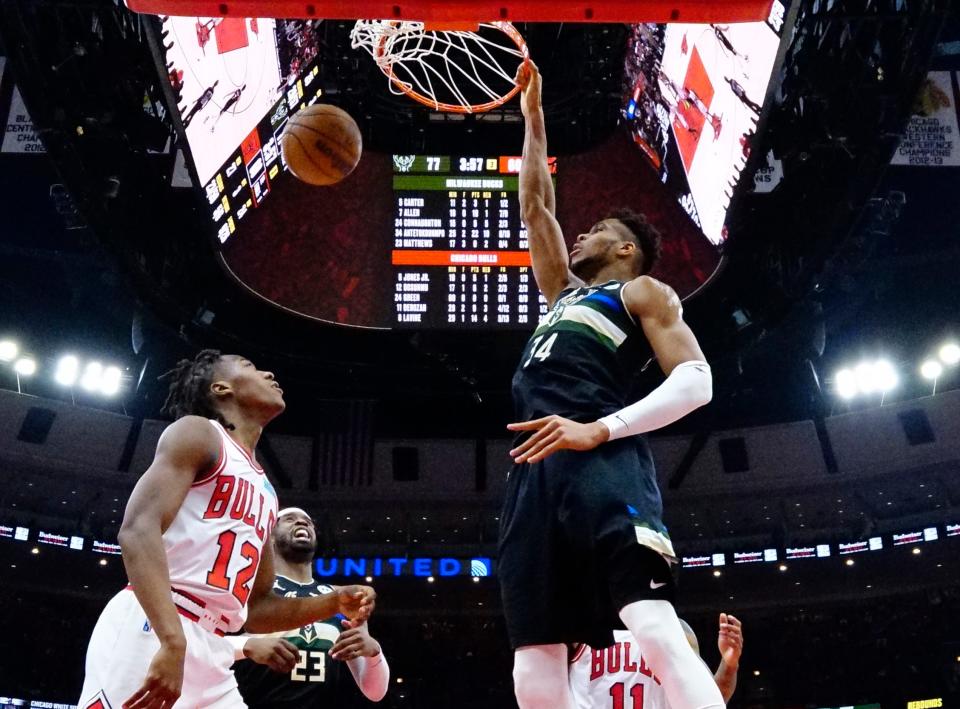 Milwaukee Bucks forward Giannis Antetokounmpo dunks the ball in front of Chicago Bulls guard Aye Dosunmu.
