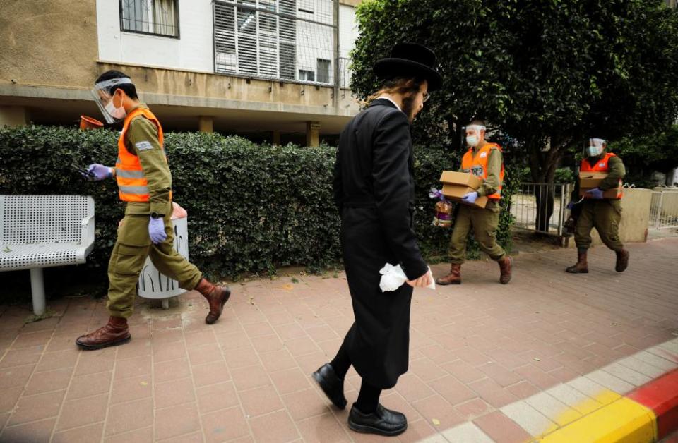 Israeli soldiers deliver food to residents in Bnei Brak.