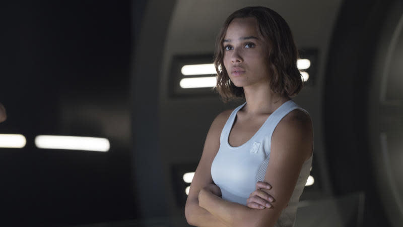 Here is a ranking of Zoe Kravitz movies and tv shows. Pictured: Zoe Kravitz standing with her arms folded as Christina in the movie Divergent. | 