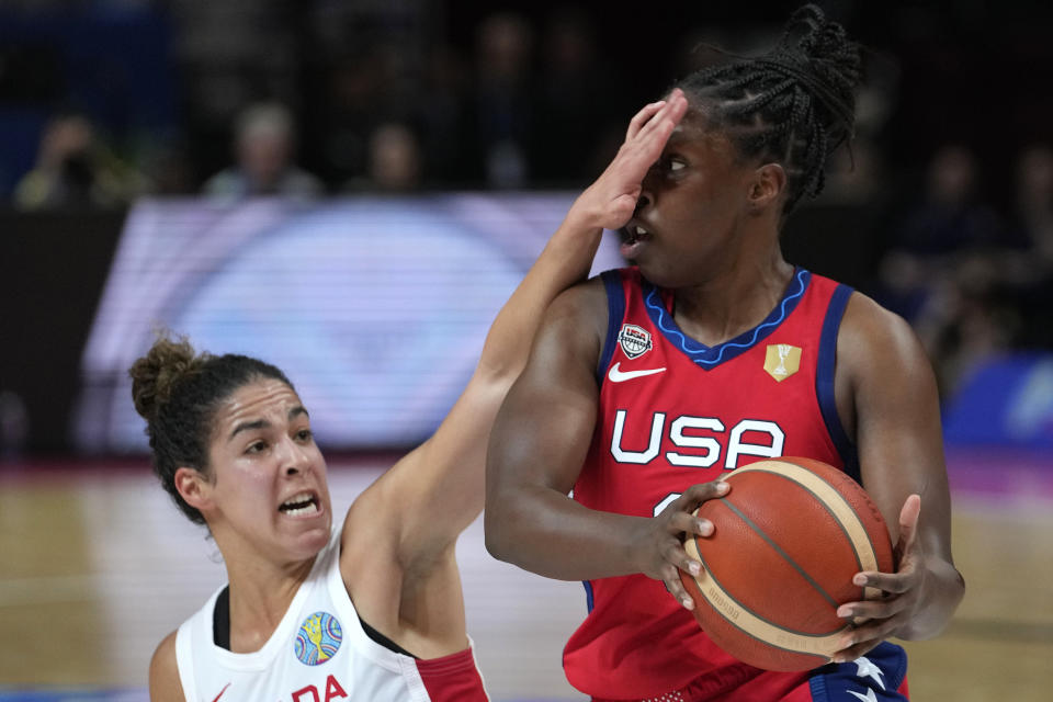 Canada's Kia Nurse, left, covers the face of United States' Chelsea Gray during their semifinal game at the women's Basketball World Cup in Sydney, Australia, Friday, Sept. 30, 2022. (AP Photo/Rick Rycroft)