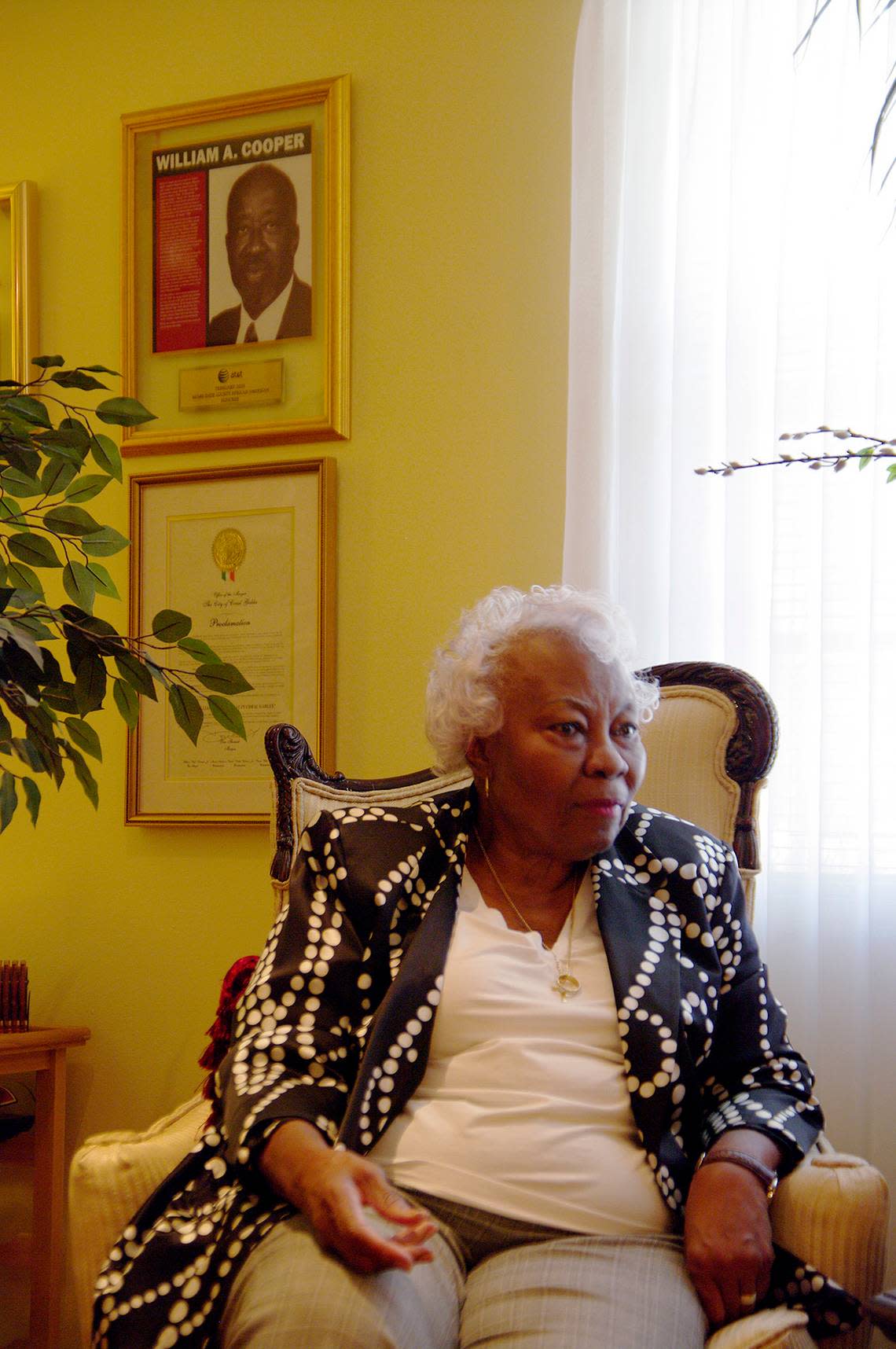 Leona Cooper is seen at her home in March 2010, with a picture of her husband William A. Cooper, who was active in the community. A park was named in his honor in Coral Gables.  