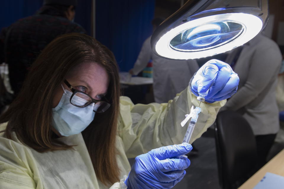 A dose of the Pfizer-BioNTech COVID-19 vaccine is prepared by Pharmacy Technician Supervisor Tamara Booth Rumsey at The Michener Institute in Toronto on Monday, Jan. 4, 2021. (Frank Gunn/The Canadian Press via AP)