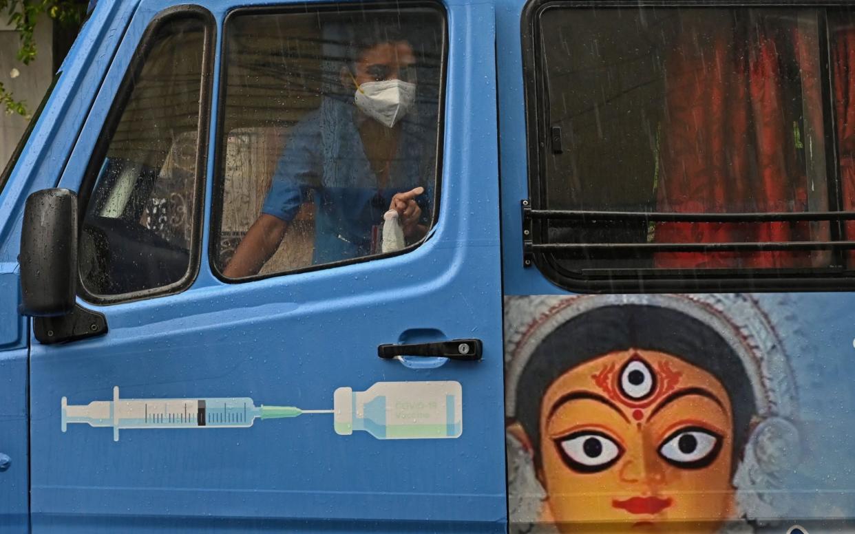 A health worker in a newly introduced 'Vaccination on Wheels' vehicle in Kolkata - Dibyangshu Sarkar/AFP