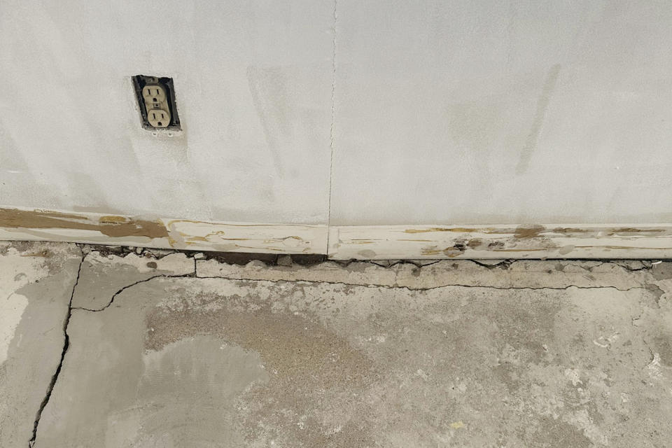 Cracks run along the floor and wall in an apartment rented by Shauna Dixon before a section of the 116-year-old Davenport apartment building later collapsed in May. The collapse left three dead, and about 50 homeless without their possessions. (Shauna Dixon via AP)