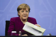 CORRECTS DAY - German Chancellor Angela Merkel attends a news conference with Bavarian state governor Markus Soeder and the Mayor of Berlin Michael Mueller after a meeting at the chancellery in Berlin, Germany, Wednesday, March 3, 2021. German Chancellor Angela Merkel conferred with the governors of the country's 16 states to discuss how to move forward with coronavirus restrictions (AP Photo/Markus Schreiber, Pool)