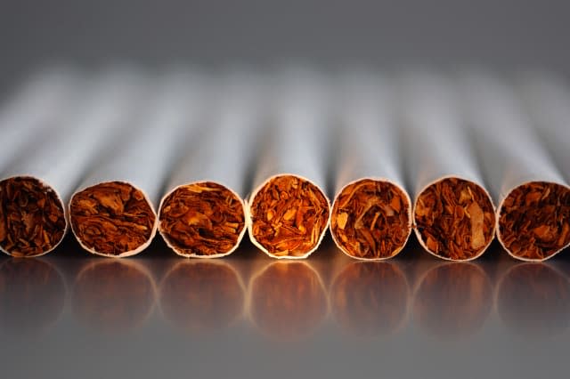 Close-up of few cigarettes on reflecting backgr.