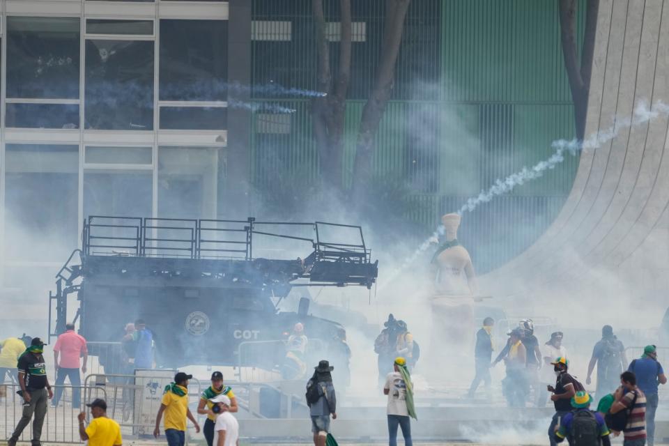 Protesters, supporters of Brazil's former President Jair Bolsonaro, clash with the police after they stormed the Planalto Palace in Brasilia, Brazil, on Sunday.