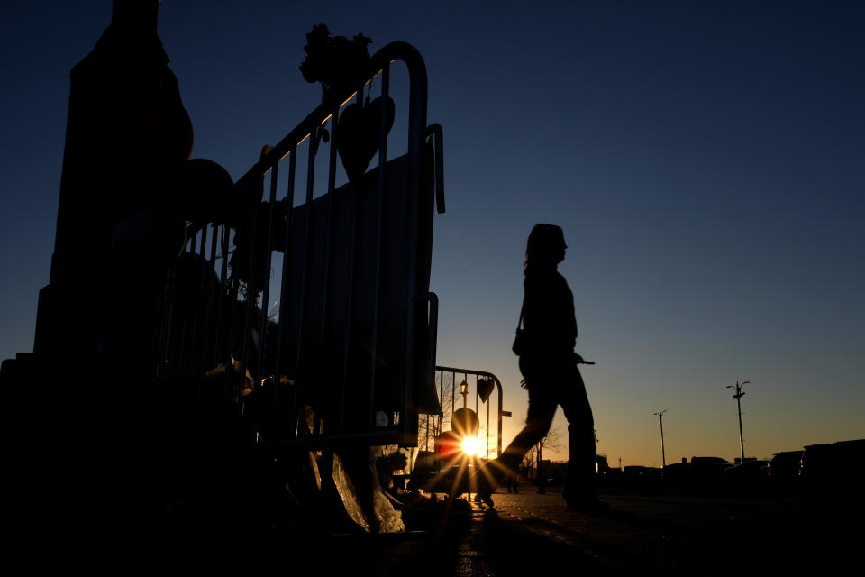 FILE - A woman walks away after viewing a memorial dedicated to the victims of last week's mass shooting in front of Union Station, Sunday, Feb. 18, 2024, in Kansas City, Mo. Missouri prosecutors said Tuesday, Feb. 20, that two men have been charged with murder in last week’s shooting that killed one person and injured multiple others after the Kansas City Chiefs’ Super Bowl parade. (AP Photo/Charlie Riedel, File)