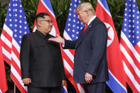 <p>President Donald Trump gestures toward the meeting site with North Korea leader Kim Jong Un at the Capella resort on Sentosa Island Tuesday, June 12, 2018 in Singapore. (Photo: Evan Vucci/AP) </p>