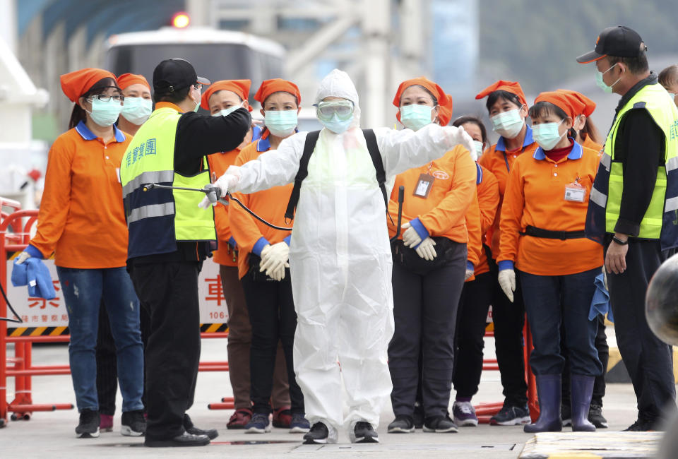 FILE - In this Saturday, Feb, 8, 2020, file photo, an epidemic prevention worker in a protective suit stands by to get on board the cruise ship SuperStar Aquarius which was denied right to dock by Japan over fears of spread of virus and returned to dock at Keelung port in New Taipei City, Taiwan. Taiwan’s exclusion from the World Health Organization is pitting health concerns against geopolitics during the current crisis over a new virus. Taiwan has called repeatedly for it to be allowed to participate in WHO, from which it has been barred by China. So strong is China’s diplomatic pressure that Taiwan can no longer take part in the organization’s annual World Health Assembly, even as an observer. (AP Photo/Chiang Ying-ying, File)