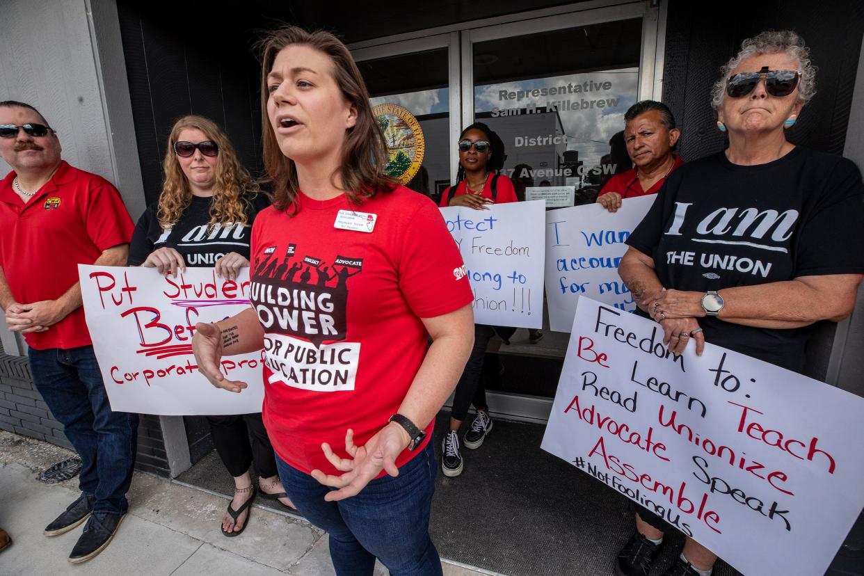 Polk Education Association President Stephanie Yocum and other union representatives protest outside the Winter Haven office of Republican state Rep. Sam Killebrew on Thursday. They were protesting HB 1445, which takes aim at most public-sector unions, except police, firefighters and corrections officers.